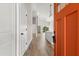 Bright, airy entryway showcasing wood floors, modern lighting, and a view into the kitchen at 817 E Mcdonald Ave, Eustis, FL 32726
