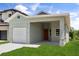 A modern home with a one-car garage, neutral exterior, and green grass at 817 E Mcdonald Ave, Eustis, FL 32726