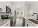 Modern kitchen featuring stainless steel appliances, marble counters, and an island sink at 817 E Mcdonald Ave, Eustis, FL 32726