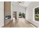 Living room with modern fireplace, high ceiling, sliding doors and wood flooring at 817 E Mcdonald Ave, Eustis, FL 32726