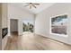 Bright living room with vaulted ceiling, modern fireplace, and sliding glass doors to balcony at 817 E Mcdonald Ave, Eustis, FL 32726