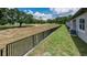Backyard of a house, featuring grass and a black fence at 8584 Magnificent Ln, Groveland, FL 34736