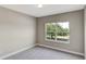 Bedroom featuring a window with views of a large tree at 8584 Magnificent Ln, Groveland, FL 34736