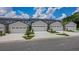 Row of modern townhomes, each featuring an attached single-car garage and manicured landscaping at 8584 Magnificent Ln, Groveland, FL 34736