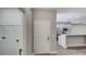 Hallway view into the kitchen with stainless appliances and laundry room at 8584 Magnificent Ln, Groveland, FL 34736