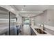 Well-lit kitchen with stainless steel appliances, quartz countertops and stylish gray cabinets at 8584 Magnificent Ln, Groveland, FL 34736