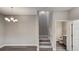 Open-concept living space with staircase leading upstairs and a view of the half-bathroom at 8584 Magnificent Ln, Groveland, FL 34736