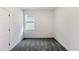 Minimalist bedroom with neutral walls, soft carpeting, and a window that provides natural light at 9112 Wildlight Trl, Wildwood, FL 34785