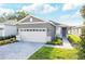 Beautiful single-story home showcasing a neutral color scheme, a two-car garage, and manicured landscaping at 9112 Wildlight Trl, Wildwood, FL 34785