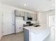 Bright kitchen with white quartz countertops, gray cabinets, and stainless steel appliances at 9112 Wildlight Trl, Wildwood, FL 34785