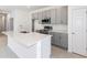 Modern kitchen featuring stainless steel appliances, quartz countertops, and gray cabinets, offering a sleek design at 9112 Wildlight Trl, Wildwood, FL 34785