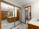 Bathroom featuring wood cabinets, tiled floors, a shower room, and a big mirror at 985 Willow Run Ln, Winter Springs, FL 32708