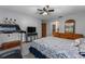Spacious bedroom with a ceiling fan, TV, treadmill, and a full bathroom view at 985 Willow Run Ln, Winter Springs, FL 32708