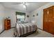 Cozy bedroom with natural light from window, ceiling fan, and closet for storage at 985 Willow Run Ln, Winter Springs, FL 32708