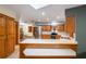 Well-lit kitchen with wood cabinetry, stainless steel appliances, and a functional breakfast bar for casual dining at 985 Willow Run Ln, Winter Springs, FL 32708