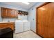 Bright laundry room with a sink, countertop, washer, dryer and overhead storage shelves at 985 Willow Run Ln, Winter Springs, FL 32708