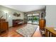 Living room with wood floors, view of the pool, and classic furnishings perfect for relaxing or entertaining at 985 Willow Run Ln, Winter Springs, FL 32708