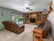 Cozy living room features built-in bookshelves, comfortable seating, and a seamless view of the sparkling backyard pool at 985 Willow Run Ln, Winter Springs, FL 32708