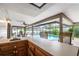 A lovely view of the screened-in pool from the covered patio bar with sink and countertop at 985 Willow Run Ln, Winter Springs, FL 32708