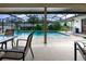 Screened-in pool area with tables and chairs, grill, and views of the beautiful backyard at 985 Willow Run Ln, Winter Springs, FL 32708