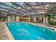 A large screened-in pool with an expansive patio, outdoor seating, and backyard entertaining space at 985 Willow Run Ln, Winter Springs, FL 32708