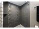Modern bathroom shower with gray tile and decorative accents; a sleek and stylish design at 985 Willow Run Ln, Winter Springs, FL 32708