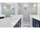 Modern bathroom featuring dual vanities, a glass-enclosed shower, and sleek fixtures for a luxurious feel at 10322 Marconi Ave, Orlando, FL 32827