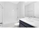 Clean bathroom showcasing a shower-tub combo with tiled walls, a modern vanity, and ample space at 10322 Marconi Ave, Orlando, FL 32827