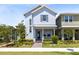 Charming two-story home with a light blue exterior, well-manicured landscaping, and a welcoming front porch at 10322 Marconi Ave, Orlando, FL 32827