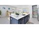 Stylish kitchen featuring a central island, stainless steel appliances, and an open layout connecting to the dining and living areas at 10322 Marconi Ave, Orlando, FL 32827