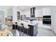 Modern kitchen with a stylish island, stainless steel appliances, and an open view to the dining and living areas at 10322 Marconi Ave, Orlando, FL 32827