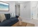 Bright living space featuring a comfortable blue sofa, stylish decor, and a contemporary clock at 10322 Marconi Ave, Orlando, FL 32827