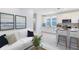 Cozy living room with modern decor, adjacent to a kitchen with white cabinets and granite countertops at 10322 Marconi Ave, Orlando, FL 32827