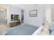 Relaxing primary bedroom with a TV, walk-in closet, and an ensuite bathroom with modern features at 10322 Marconi Ave, Orlando, FL 32827