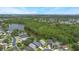 Aerial shot of houses nestled among greenery along a serene lake at 104 Yorktown Pl, Sanford, FL 32771