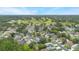 Aerial view of neighborhood homes close to green golf course at 104 Yorktown Pl, Sanford, FL 32771