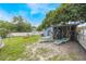 The backyard has lounge chairs, a fire pit, string lights, and trees at 104 Yorktown Pl, Sanford, FL 32771