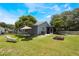 The backyard has an umbrella table, trees, a firepit, a lawn chair, and partial fencing at 104 Yorktown Pl, Sanford, FL 32771