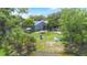 An aerial view of the backyard with a fire pit, kayaks, and seating area by the lake at 104 Yorktown Pl, Sanford, FL 32771