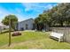Backyard featuring a fire pit, bench, trees, and a partially fenced yard at 104 Yorktown Pl, Sanford, FL 32771