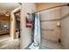 Bathroom featuring a tiled walk-in shower with a seating bench and a full closet on the side at 104 Yorktown Pl, Sanford, FL 32771