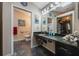 Bathroom featuring a granite countertop, framed mirror, storage shelves, and neutral wall color at 104 Yorktown Pl, Sanford, FL 32771