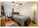 Cozy bedroom featuring hardwood floors, a window, and a dark wood headboard at 104 Yorktown Pl, Sanford, FL 32771