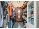 Walk-in closet with wood wardrobe, storage shelves, filled with clothes and accessories at 104 Yorktown Pl, Sanford, FL 32771