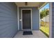 The house's covered entrance with a dark-colored door and side light at 104 Yorktown Pl, Sanford, FL 32771