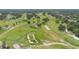 Overhead aerial view of community golf course with lush greenery and mature trees at 104 Yorktown Pl, Sanford, FL 32771