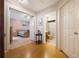 Hallway view showcasing the bedroom and bathroom with their neutral color schemes and tile flooring at 104 Yorktown Pl, Sanford, FL 32771