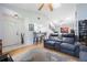Spacious living room featuring vaulted ceilings, a ceiling fan, an open floor plan, and a sofa at 104 Yorktown Pl, Sanford, FL 32771