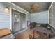 Patio with gray french doors, ceiling fan, and wicker furniture set on brick floor at 104 Yorktown Pl, Sanford, FL 32771