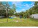 Backyard featuring water access for kayaks, with chairs under shady trees at 104 Yorktown Pl, Sanford, FL 32771